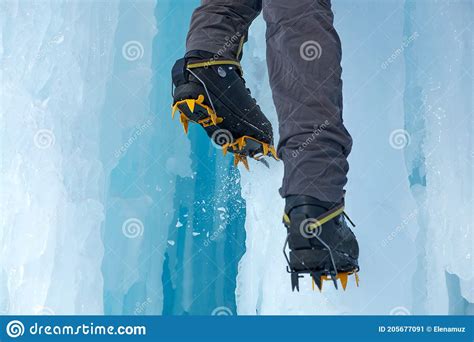 Crampons Close Up On His Feet Ice Climber On A Frozen Waterfall Shards