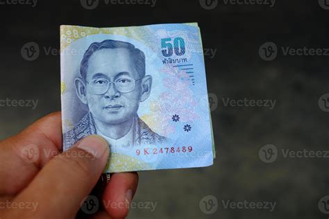 Fifty Thai Baht Money in Hand for Payment. 21486087 Stock Photo at Vecteezy
