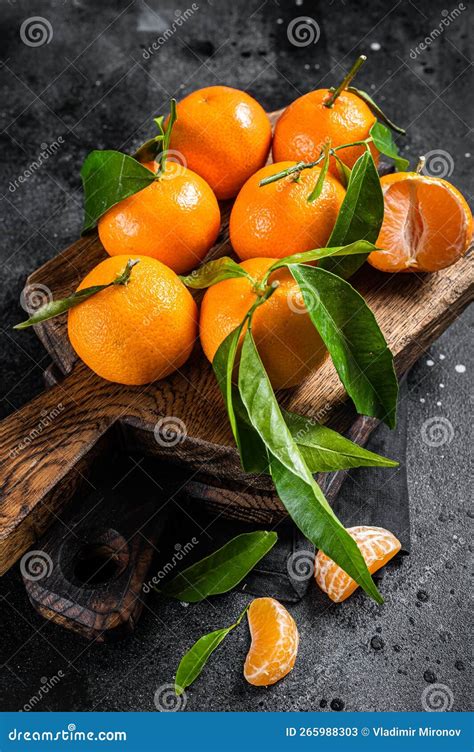 Mandarin Oranges Or Tangerines Fruits With Leaves On Wooden Board