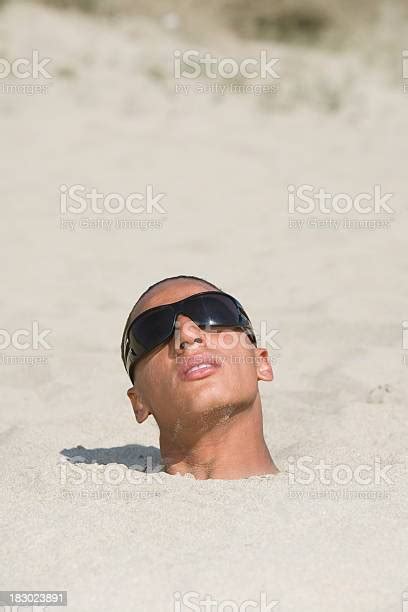 Desperate Man Buried On The Beach Stock Photo Download Image Now