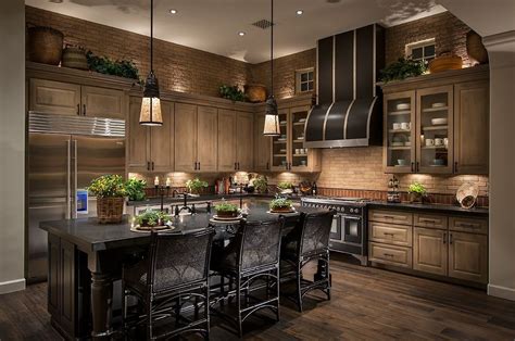 The light wood of these floors and cabinets balances the bold wall colors and dark countertops. Magnificent Kitchen Designs With Dark Cabinets