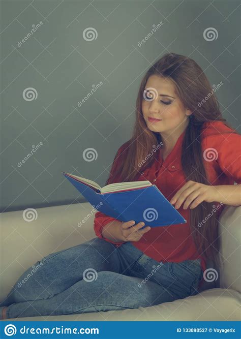 Woman Relaxing On Sofa Reading Book Stock Image Image Of Young Casual 133898527