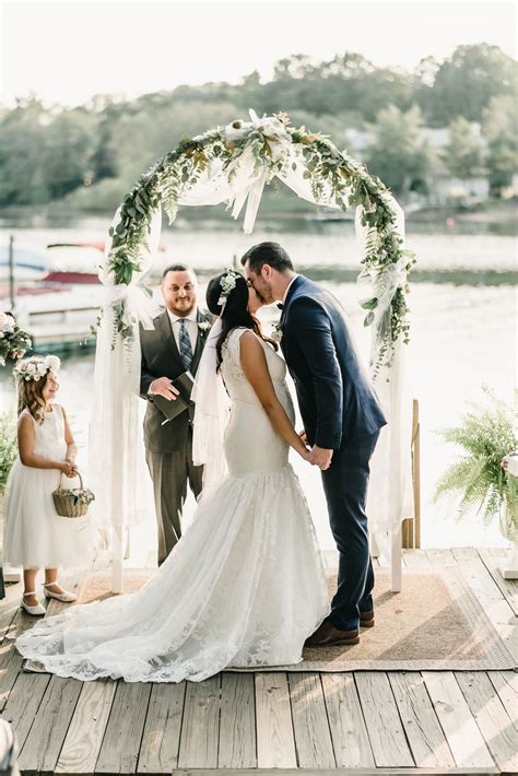 bride and groom first kiss as husband and wife lakeside ceremony outdoor ceremony decor ideas