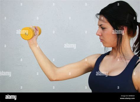 Teenage Girl Does Bicep Curls With Hand Weight Stock Photo Alamy