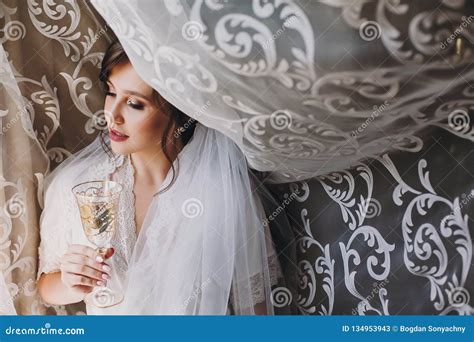 Beautiful Stylish Brunette Bride In Silk Robe And Veil Cheering With