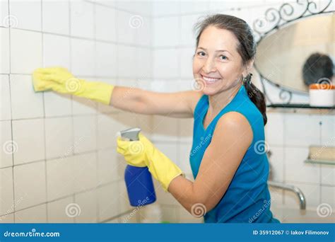 Mature Woman Cleans Bathroom Royalty Free Stock Photography Image