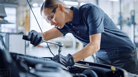 Beautiful Empowering Female Mechanic Is Working On A Car In A Car