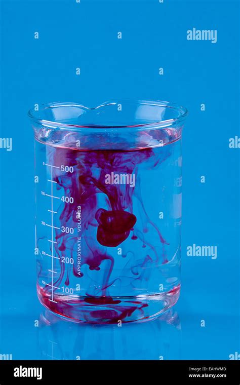 Red Food Coloring Dropped Into A Beaker Of Water Stock Photo Alamy