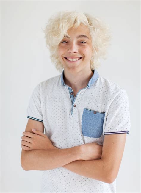 Portrait Of Cheerful Young Blond Man Smiling Looking At Camera Stock