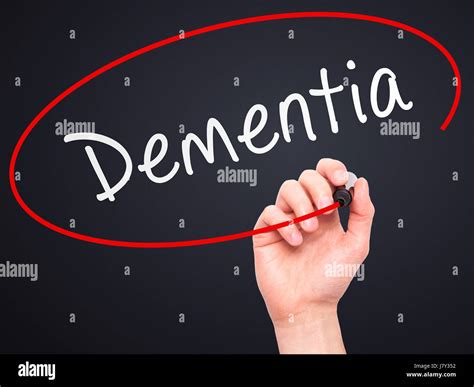 Man Hand Writing Dementia With Marker On Transparent Wipe Board