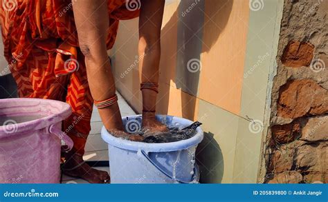 Indian Woman Washing Cloths By Hands Or Manually In Plastic Water