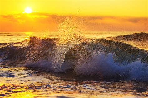 Splashing Waves At Sandy Beach During Beauty Sunset Stock Photo Image