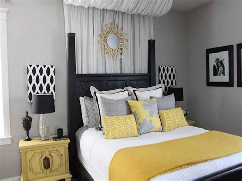 The yellow primary bedroom features a wooden bed that complements the nightstands and wood plank table flanked by white armchairs. Yellow and Gray Bedroom Decorating Ideas - Decor Ideas