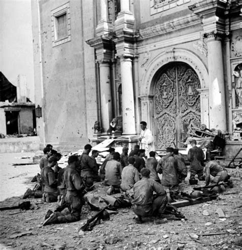 Us Soldiers Kneel During Outdoor Mass Being Conducted By A Filipino