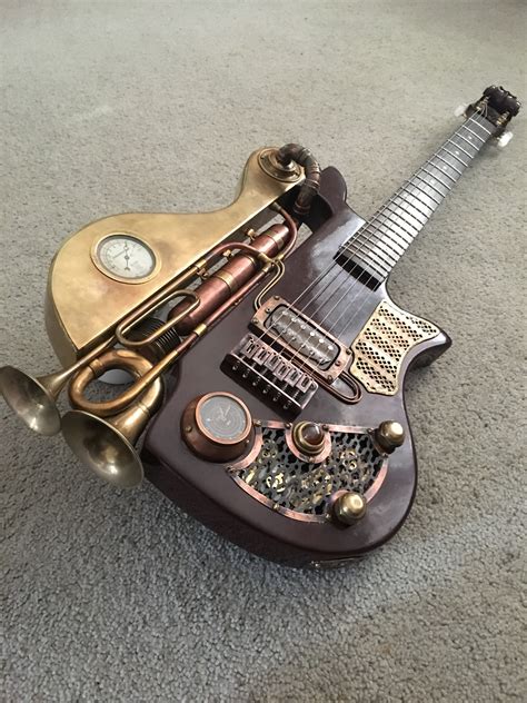 A Miniature Guitar Made Out Of Musical Instruments On The Floor With A