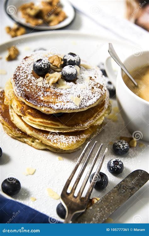 Pile Of American Pancakes With Blueberries And Powdered Sugar Stock