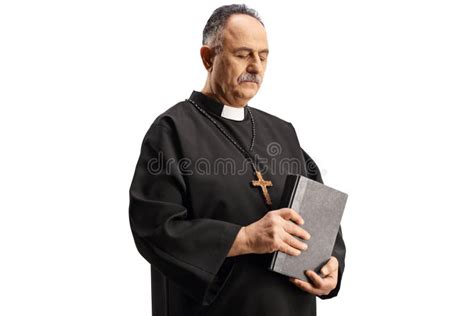 Mature Priest Holding A Bible And Looking Down Stock Photo Image Of
