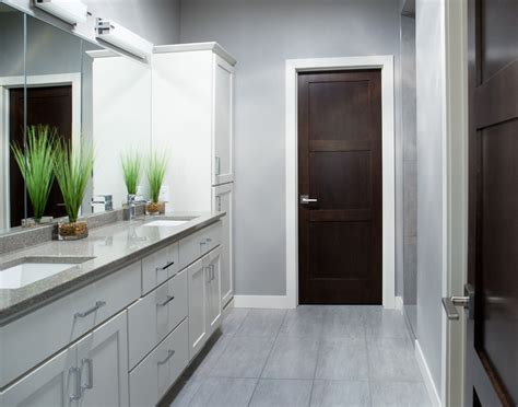 We have flat aura simply white on inside walls. White Baseboard Trim with Dark Poplar Door - Iowa Remodels