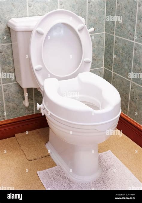 Toilet With Height Extension For Disabled Senior Person Indoors In