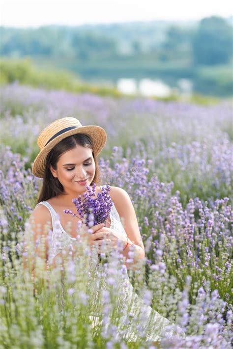 Smiling Beautiful Woman In White Dress Sniffing Lavender Flowers Stock Image Image Of