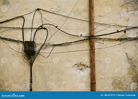 Electrical Wires On Old Brick Wall Electricity Cables Hanging From