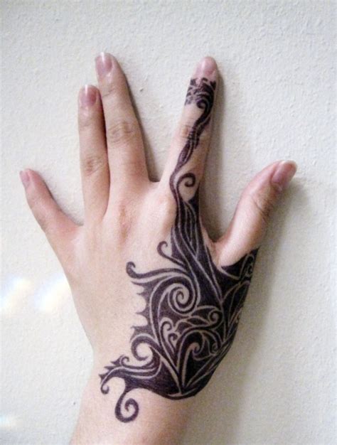 This is an awesome tattoo of a red flower with tribal vines. 40 Hand Tattoo Ideas To Get Inspire - The WoW Style