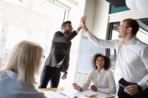 Excited Male Colleagues Give High Five Celebrating Shared Success Stock