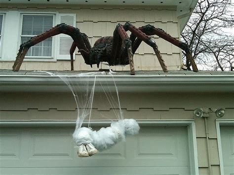A Large Spider Sculpture On Top Of A House