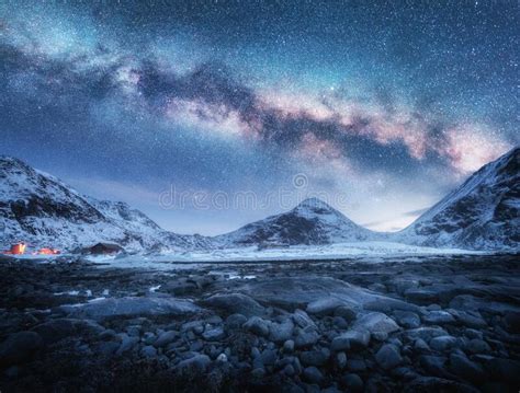 Milky Way Above Snow Covered Mountains And Stones Beach In Winter Stock
