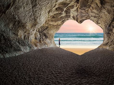 Royalty Free Photo Person Standing Outside Heart Shaped Cave Entrance
