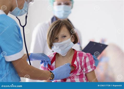 Girl Being Examined By Pediatrician Doctor With Stethoscope Tool Stock