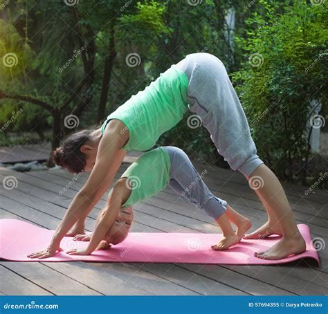 Mother And Daughter Doing Exercise Practicing Yoga Outdoors Stock Image