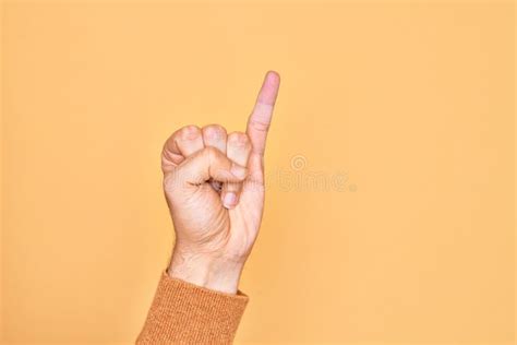 Hand Of Caucasian Young Man Showing Fingers Over Isolated Yellow