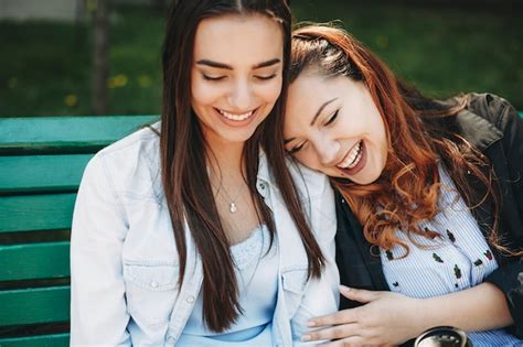Premium Photo Close Up Portrait Of Two Amazing Girlfriends Having Fun Outside On A Bench While