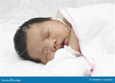 Baby Infant Sleeping On White Bed And Wear Gloves Stock Photo Image