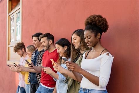 Young Multiracial Group Of Friends Using Mobile Smartphone Outdoor Stock Image Image Of