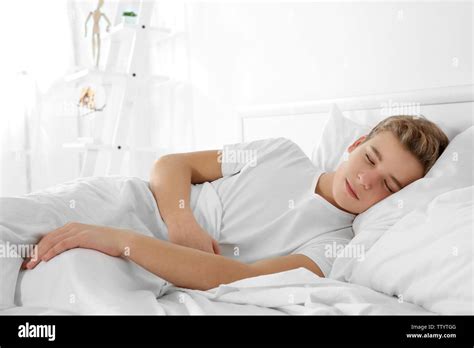 Cute Teenager Boy Sleeping In Bed At Home Stock Photo Alamy