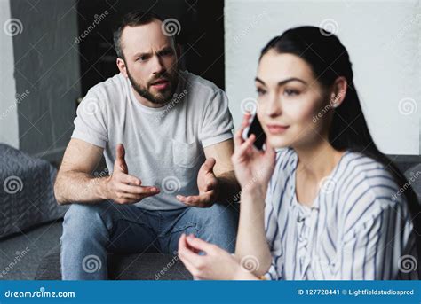 Angry Man Talking To His Wife While She Talking By Phone Stock Image Image Of Youngadult