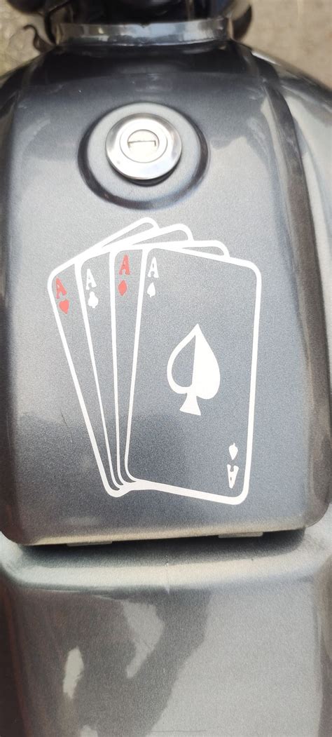 Three Playing Cards On The Back Of A Moped