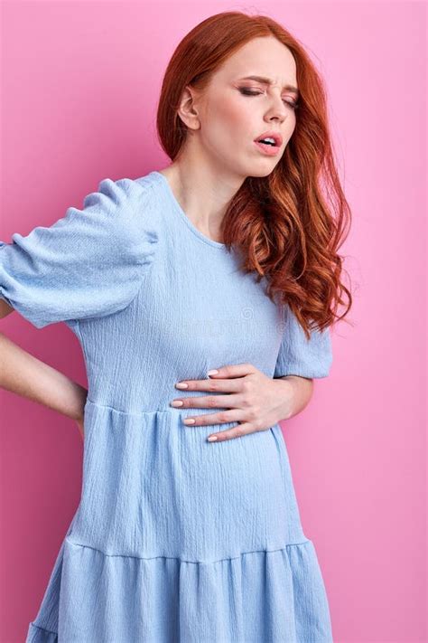 Portrait Of Redhead Pregnant Woman Having Pain In Back Stock Image