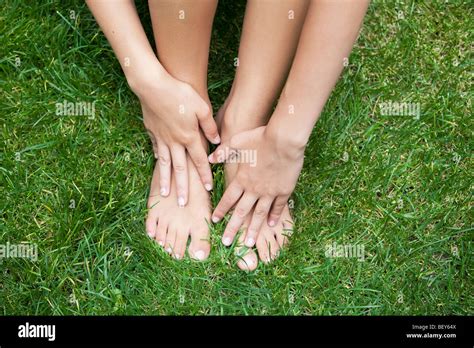 Young Woman Hands And Feet On Meadow Stock Photo Alamy