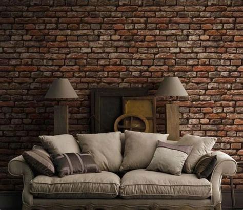 The rough brick on the wall contrasts with the soft furniture in front