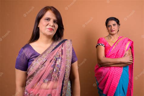 premium photo two mature indian women wearing sari indian traditional clothes together