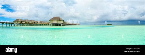 Panoramic Landscape Of Maldives Beach With Overwater Bungalow Stock