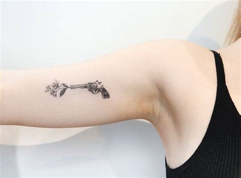 Flower Gun Tattoo On The Inner Arm