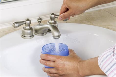Pouring Water Into Cup From Bathroom Sink Stock Image Image Of Hands