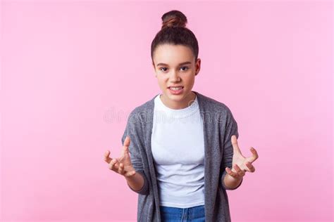 Portrait Of Irritated Brunette Girl Raising Hands Looking At Camera