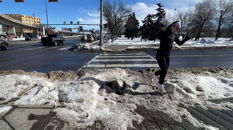 Download A Woman Running On A Snow Covered Street
