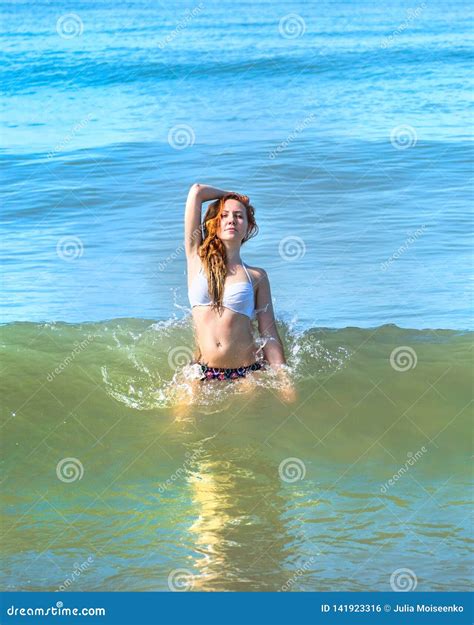 Beautiful Girl In Bikini Posing On A Deserted Beach White Sand