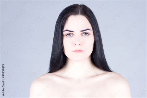 Smooth Face Of A Woman With Dark Hair Gray Eyes And Fair Skin Stock